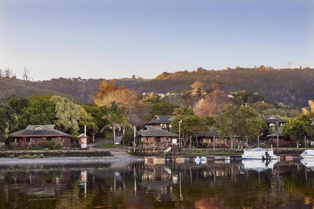 Scenic waterfront view of riverside cottages nestled among lush trees