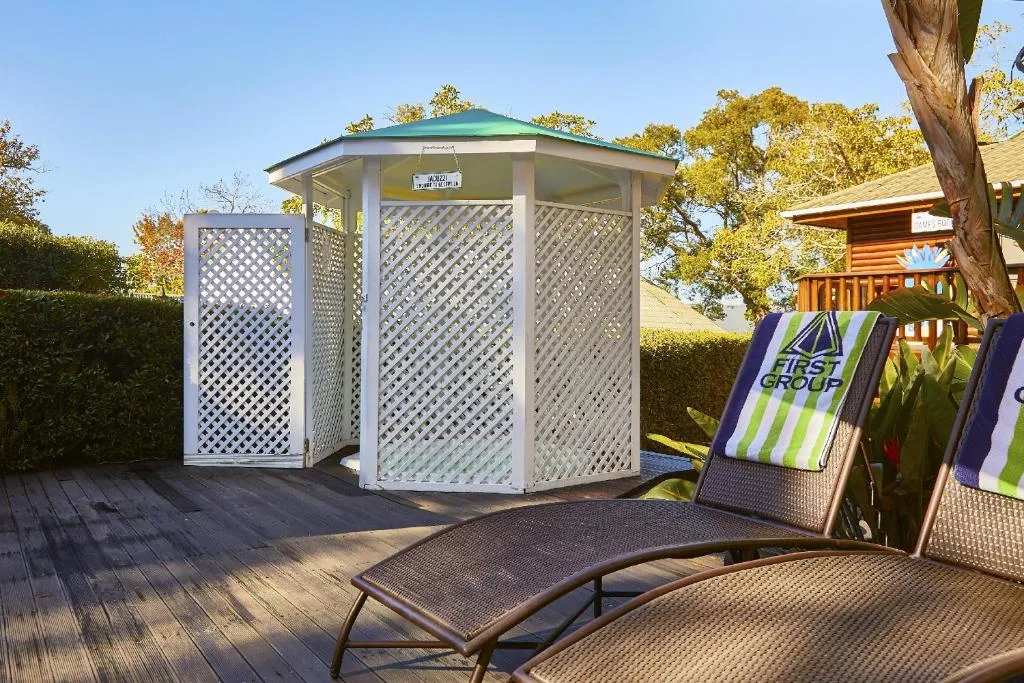 Wooden deck with lounge chairs and latticed gazebo structure