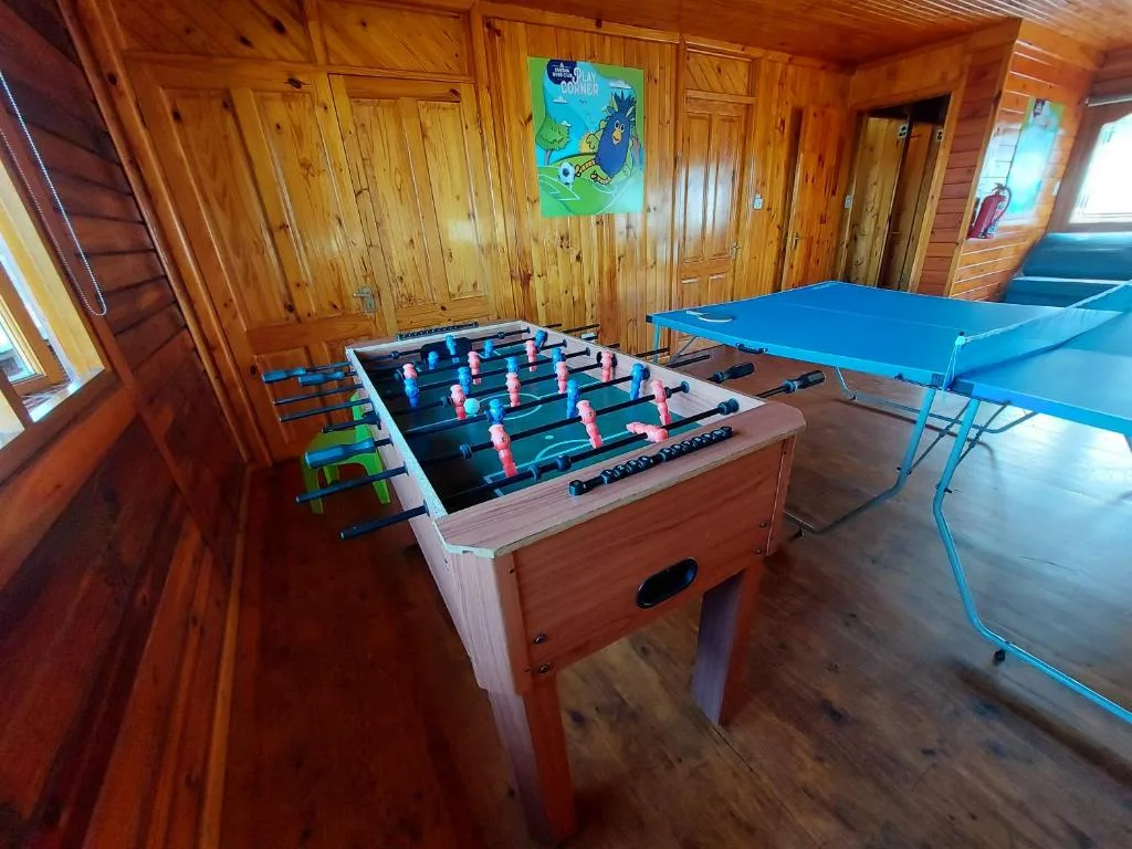 Foosball table and ping pong table in wooden recreation room
