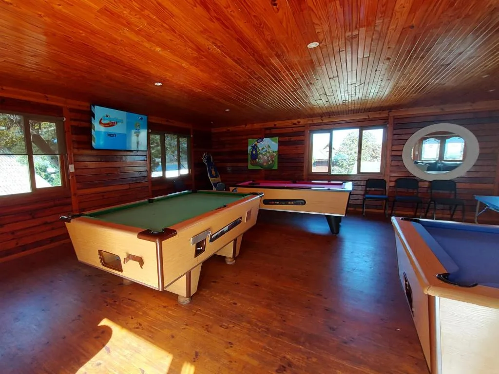 Recreation room with pool tables, air hockey, and wooden beams
