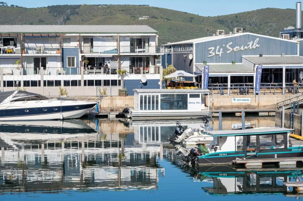 Waterfront apartment building with boat mooring and lagoon views, Knysna