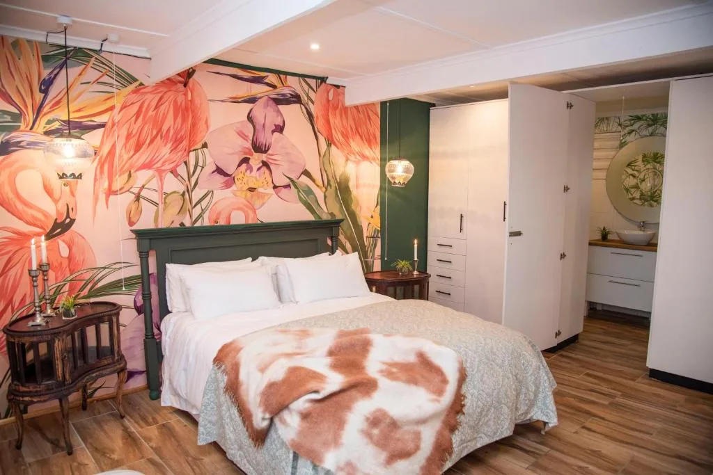 Modern bedroom with vibrant floral mural, queen bed, and built-in wardrobe