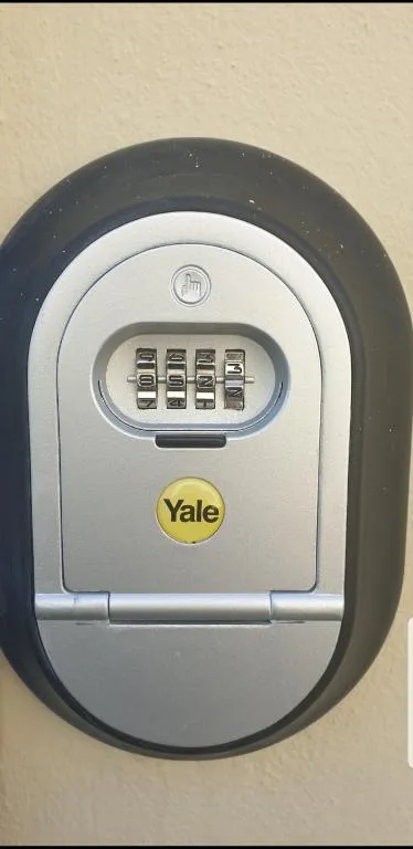Yale combination key lock mounted on exterior wall for secure access