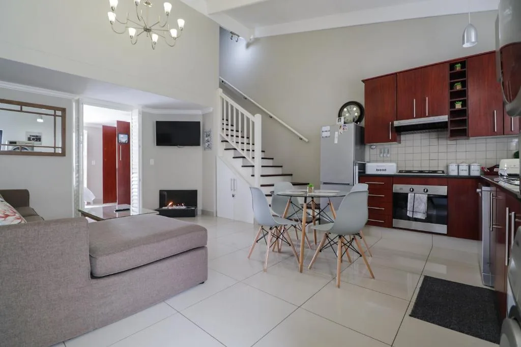 Open-plan dining area with round table and modern chairs in contemporary space