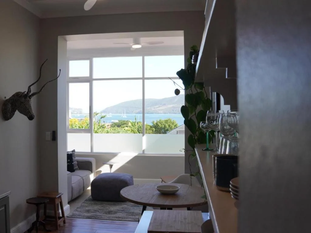 Modern lounge with lagoon views through large windows and contemporary furnishings