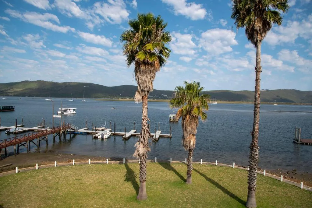 Knysna Lagoon waterfront view with moored boats and green hills