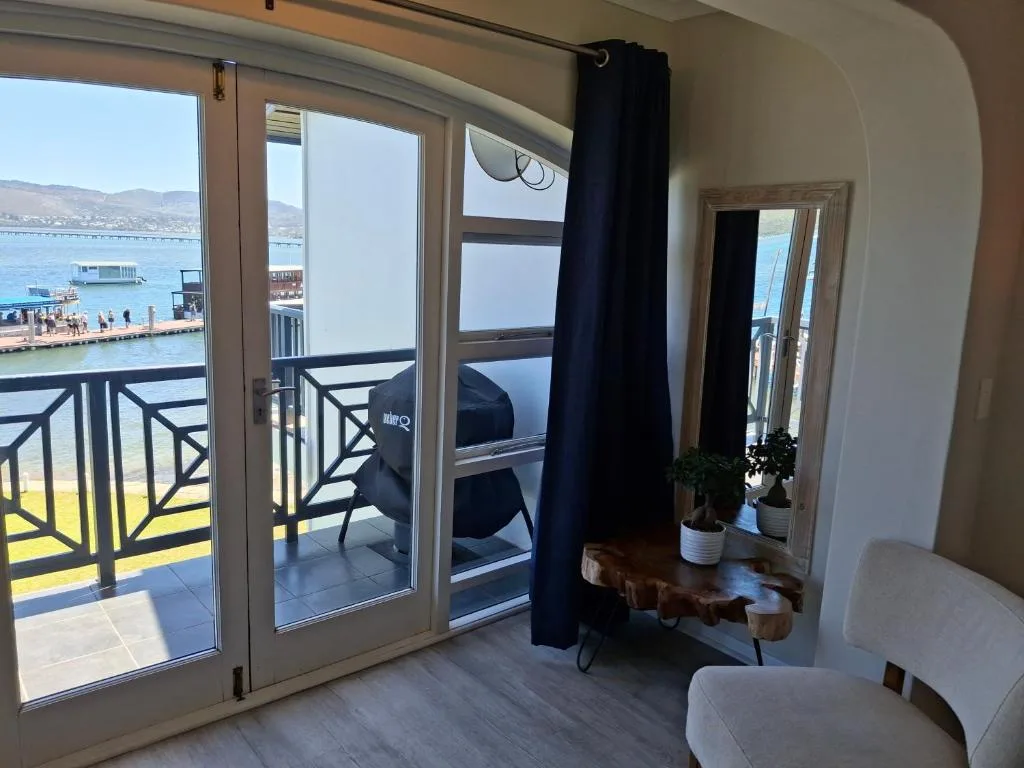 Waterfront view of Knysna lagoon and mountains from modern apartment balcony