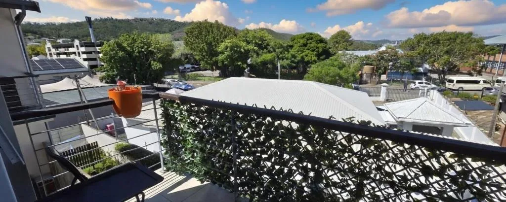 Modern balcony with shade screen overlooking Knysna mountains and town