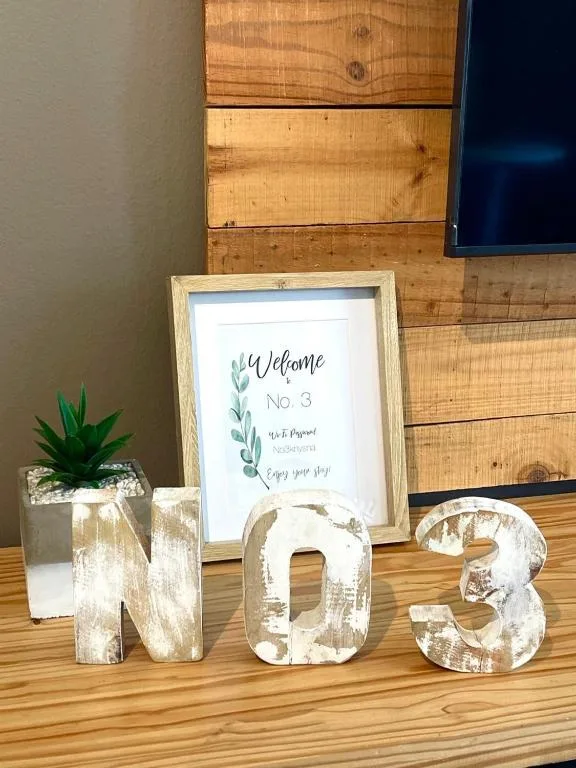 Welcome sign and decorative wooden numbers on wooden table