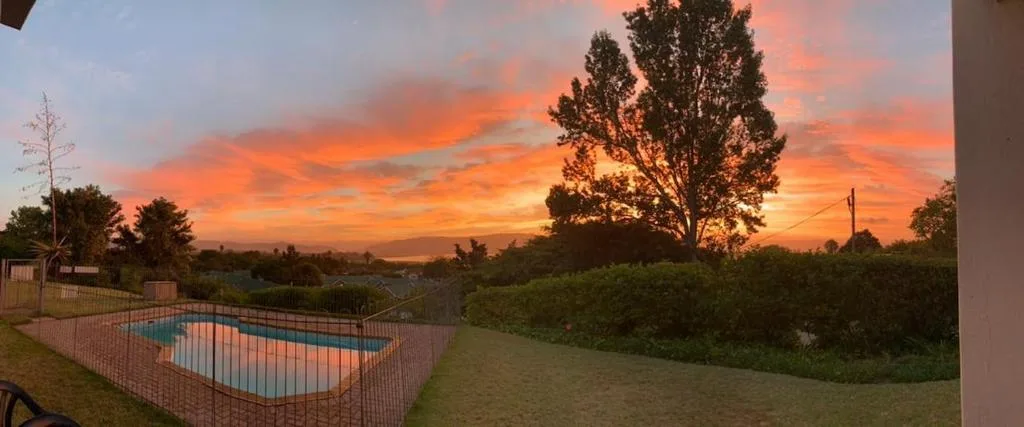 Stunning sunset over Knysna valley with pool and manicured gardens