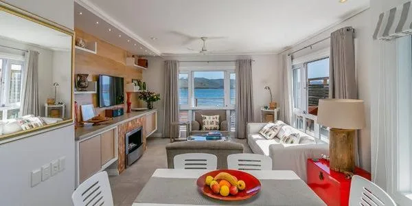 Waterfront apartment lounge with ocean views and modern furnishings