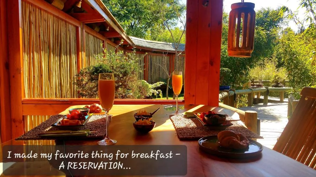 Outdoor dining area with breakfast spread and garden views