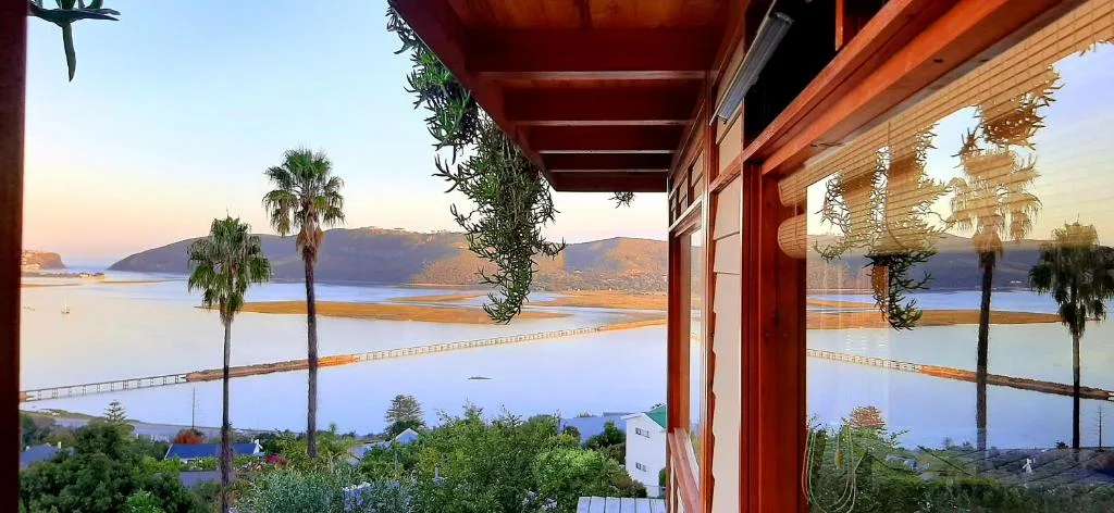Scenic lagoon and mountain vista from covered deck at sunset