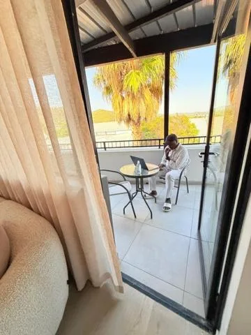 Spacious covered balcony with table and chairs overlooking lagoon views