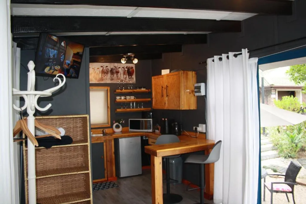 Modern kitchen with wooden cabinetry, stainless steel appliances, and counter seating