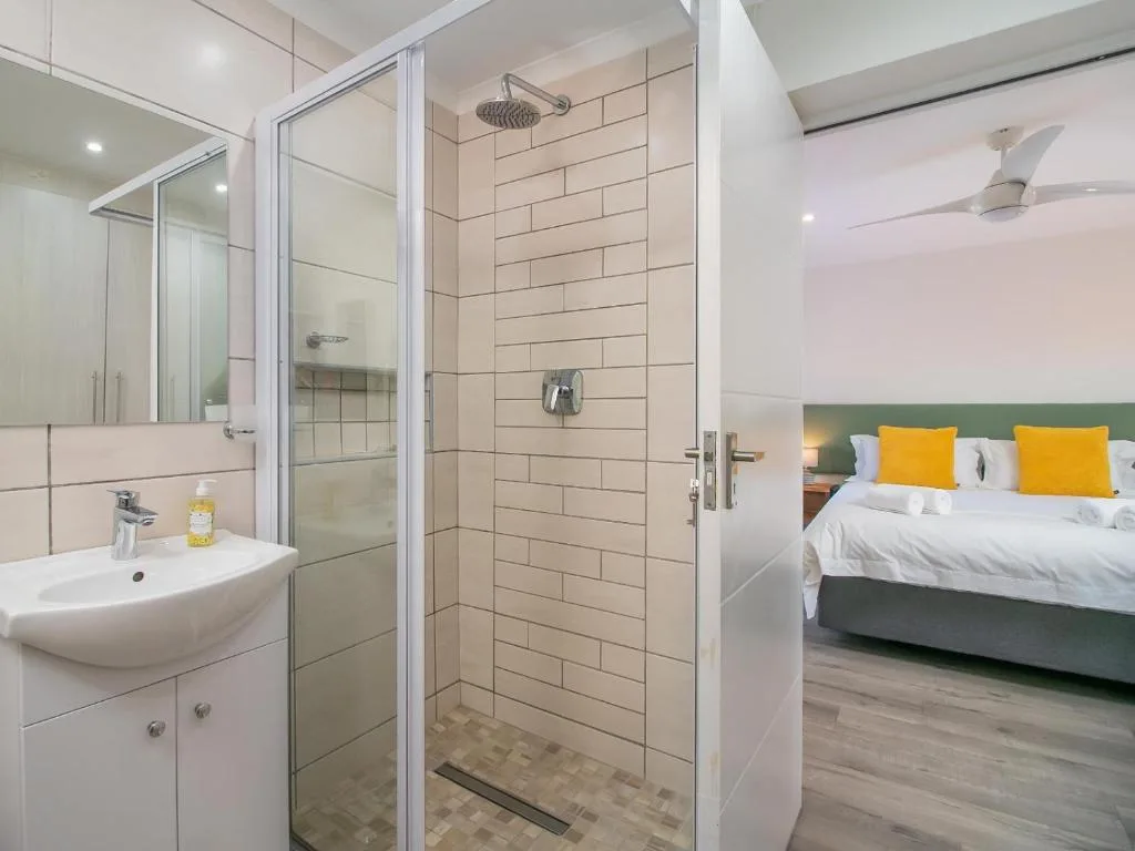 Modern bathroom with glass shower enclosure and white vanity sink