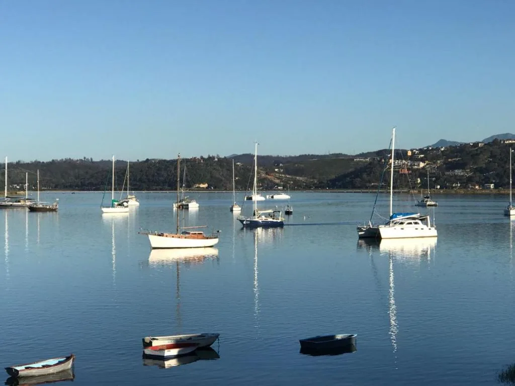 Scenic lagoon view with sailboats moored in calm blue waters