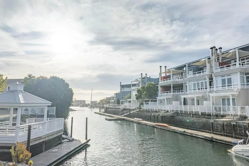 Waterfront canal with charming white buildings and moored boats