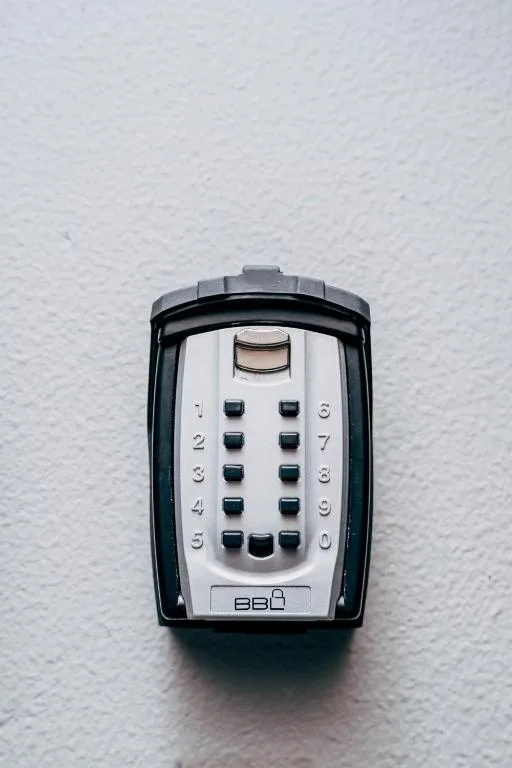 Secure keypad entry device mounted on white textured wall surface