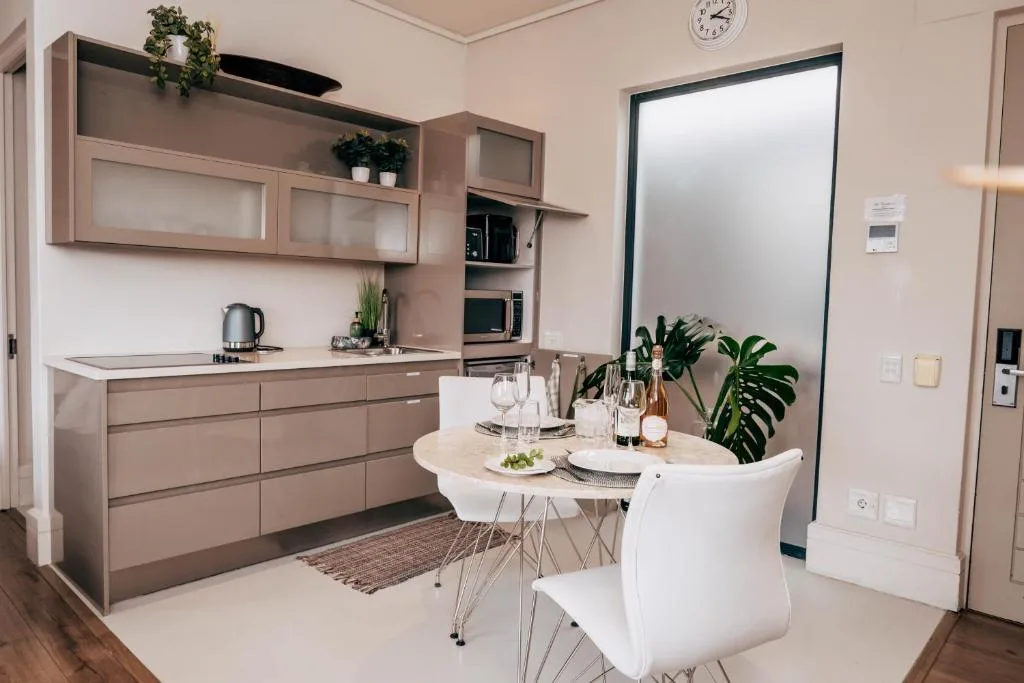 Modern kitchen with dining area, cabinetry, and dining table setup