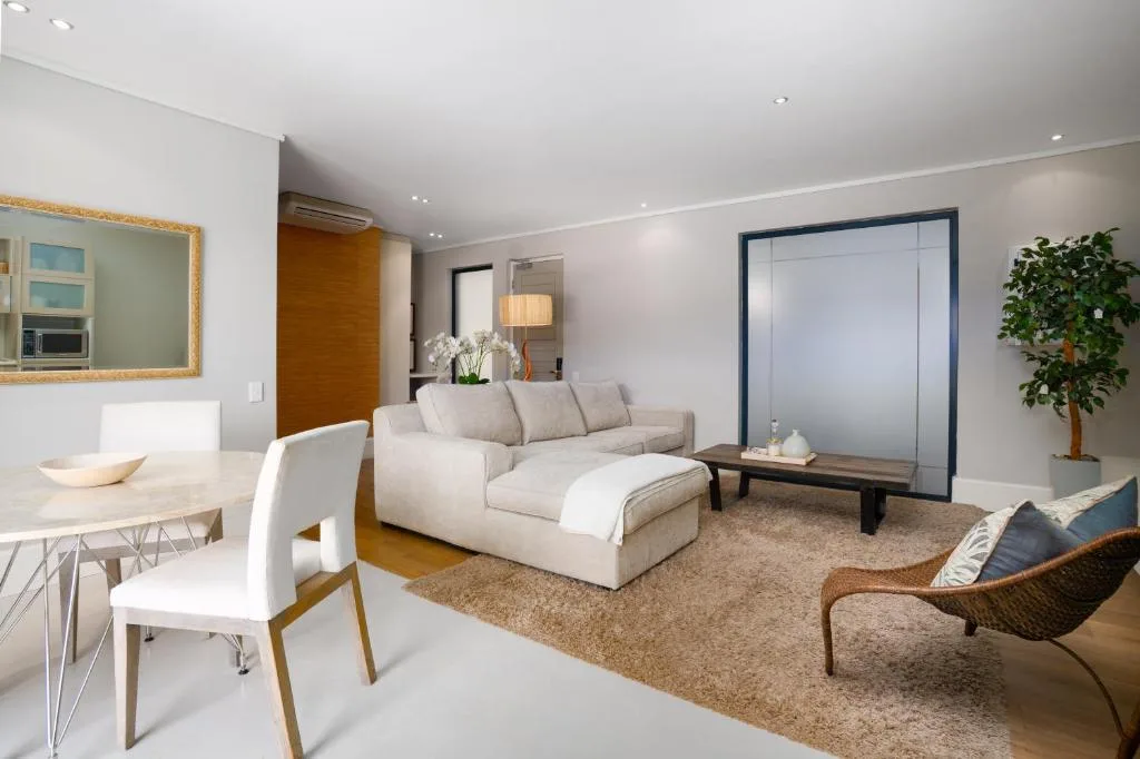Modern open-plan lounge with cream sectional sofa and contemporary furnishings