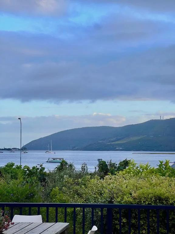 Knysna Lagoon scenic vista with mountains and moored sailboats at dusk