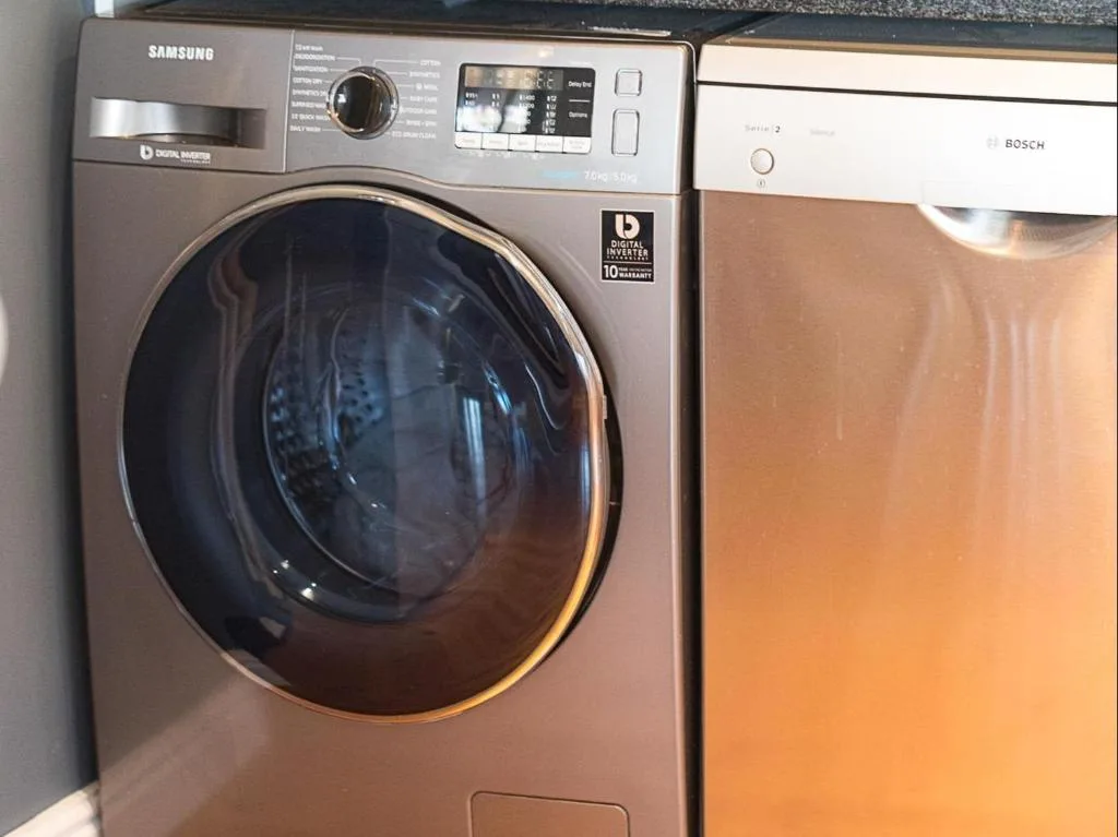 Modern Samsung washing machine and Bosch dishwasher in utility area