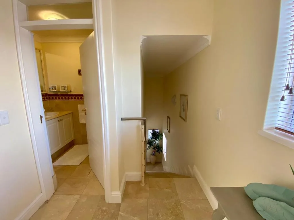 Interior hallway with bathroom entrance and tiled flooring visible