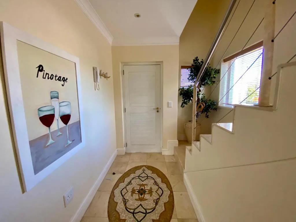 Hallway with Pinotage wine poster and decorative rug