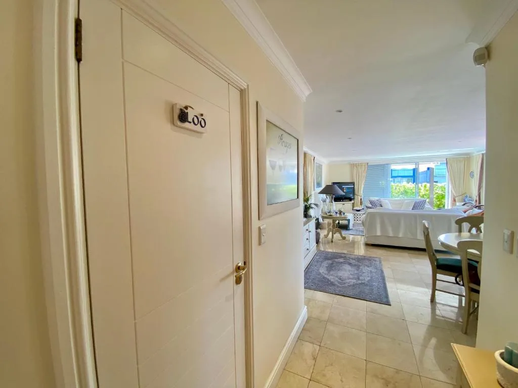 Modern hallway with loo door and open-plan living space beyond