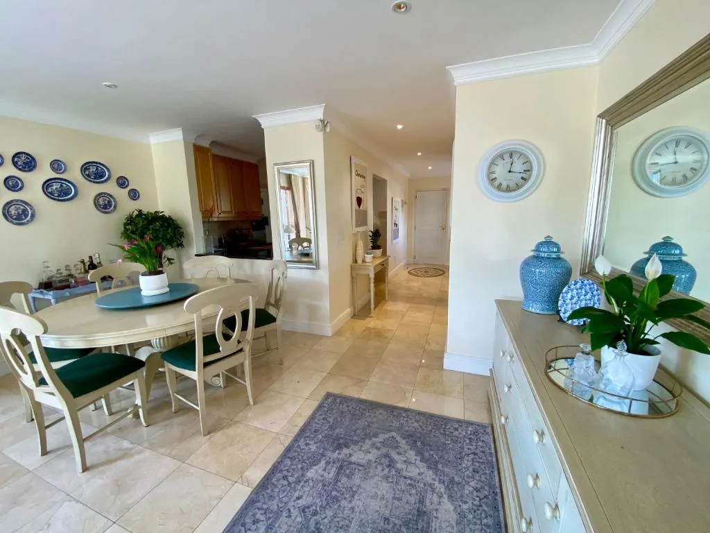 Elegant dining area with round table, chairs, and decorative blue plates