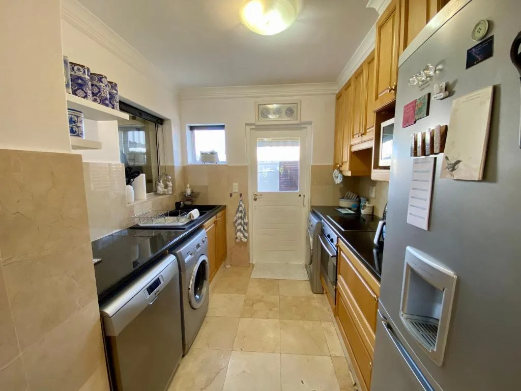 Modern kitchen with stainless steel appliances and wooden cabinetry