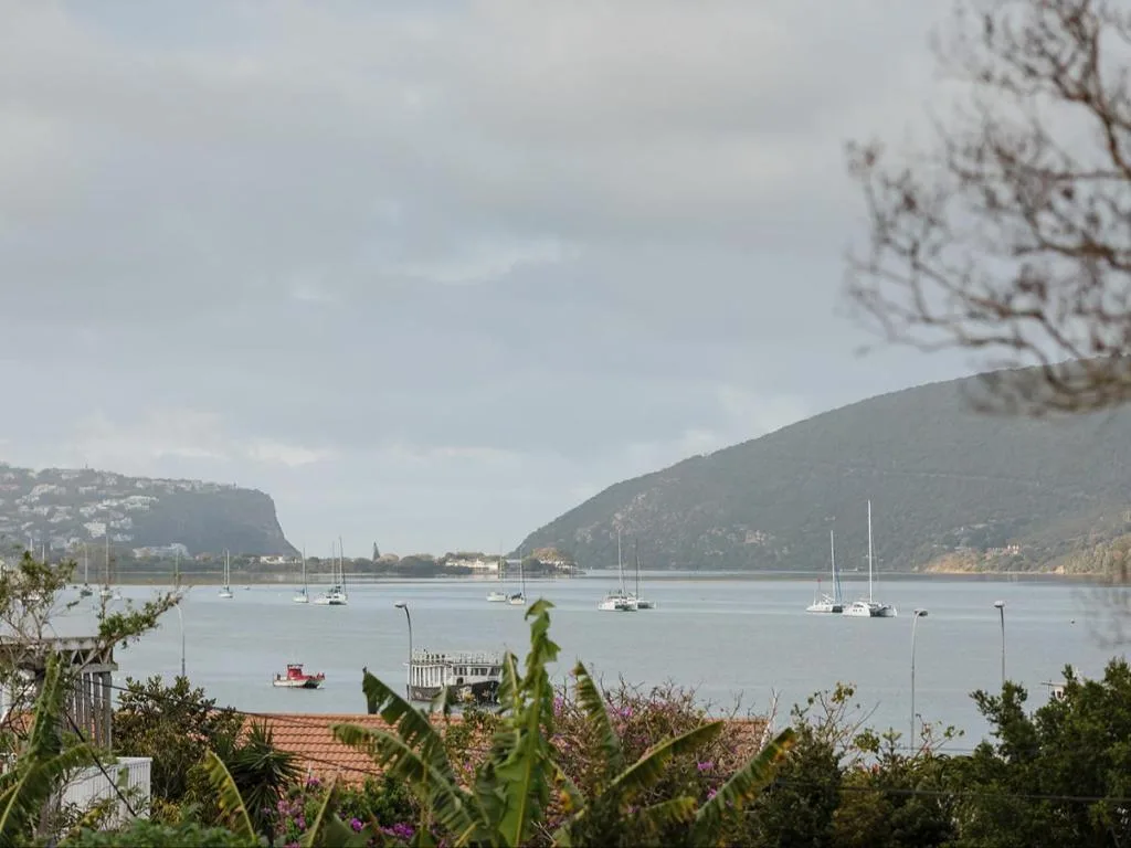 Scenic Knysna lagoon view with moored sailboats and mountain backdrop