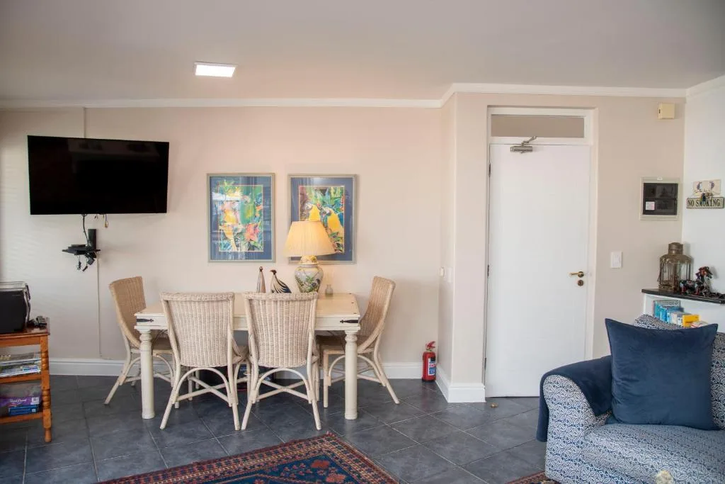 Open-plan living area with dining table, TV, and comfortable seating