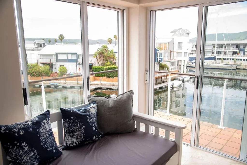 Waterfront lagoon view through large windows and glass doors
