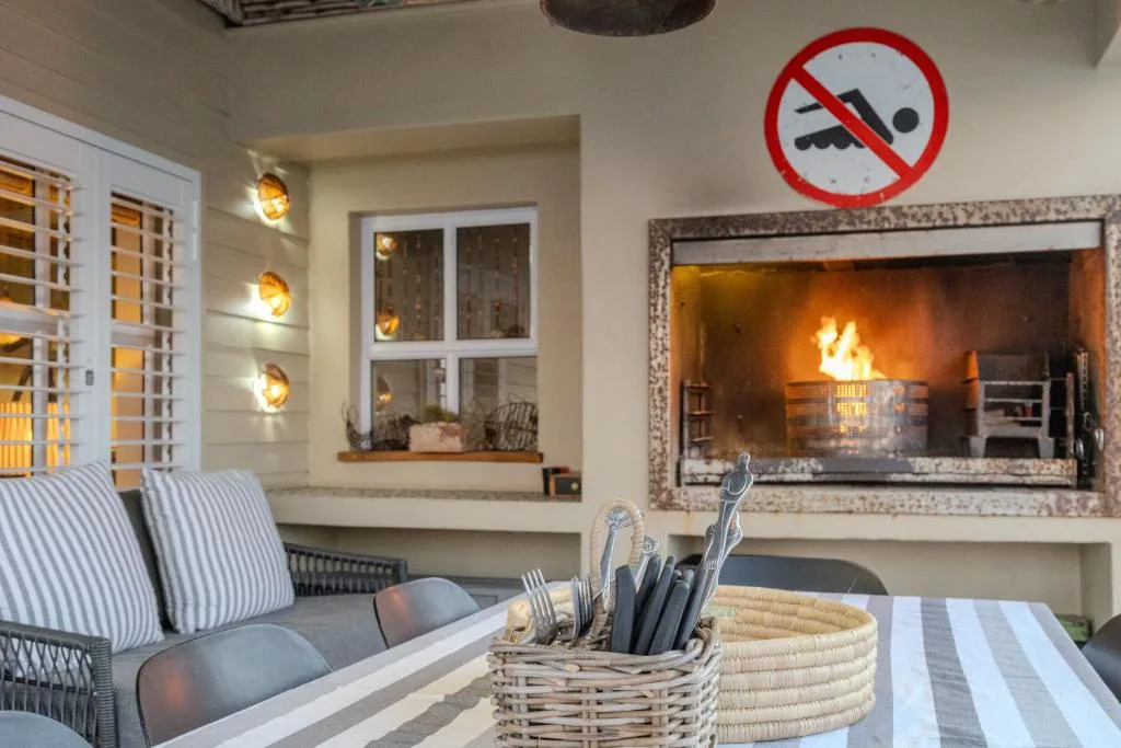 Modern lounge with fireplace, comfortable seating, and warm lighting