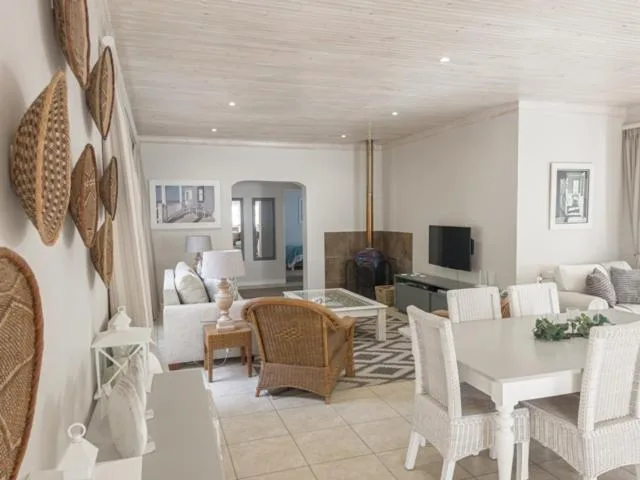Bright open-plan lounge with woven basket wall art and fireplace