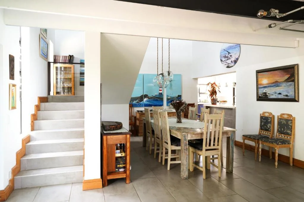 Spacious dining area with wooden table and chairs, open plan interior design