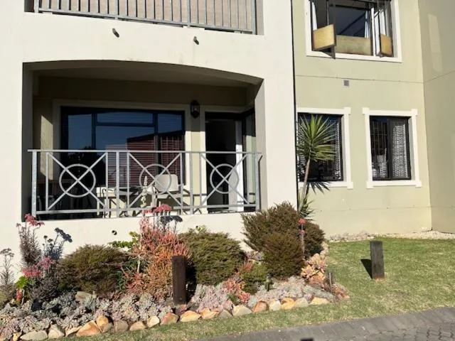 Spacious wooden deck with white railings and outdoor seating area