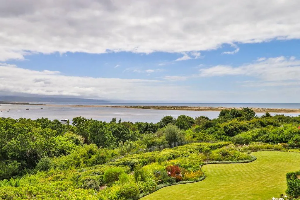 Expansive lagoon and ocean vista with lush green garden landscaping below