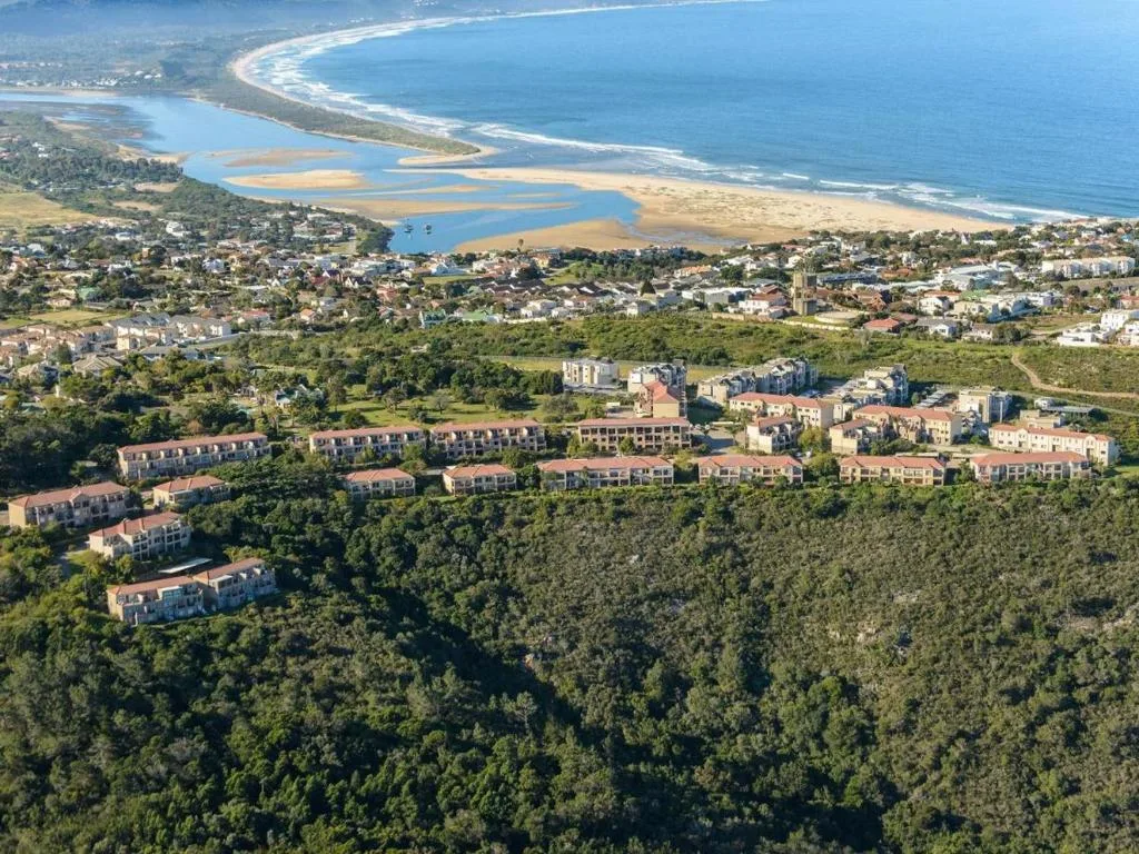 Aerial view of Plettenberg Bay with lagoon, beach, and coastal town below