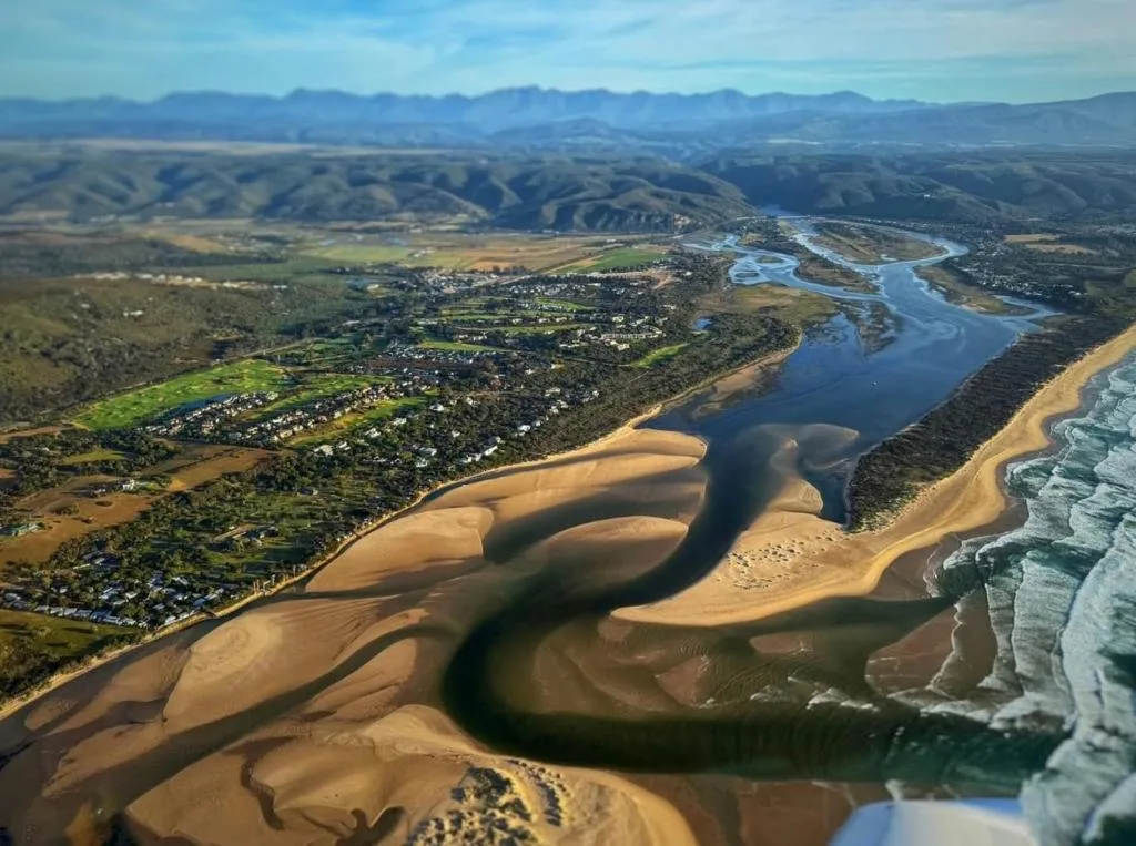 Aerial view of Piesang Valley with river, beach, and mountains