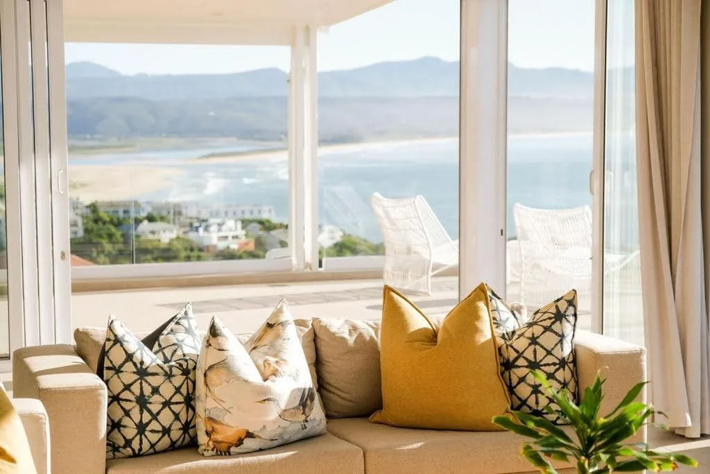 Expansive lagoon and mountain vista through floor-to-ceiling windows from lounge