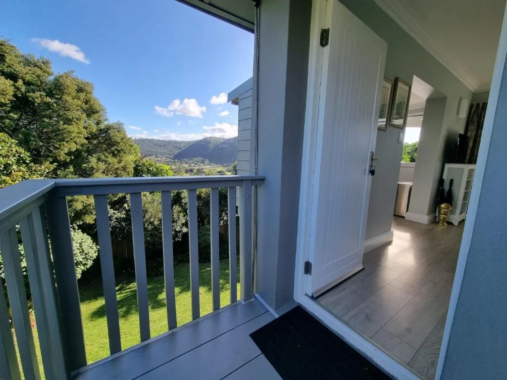 Modern balcony with mountain views and garden landscape below