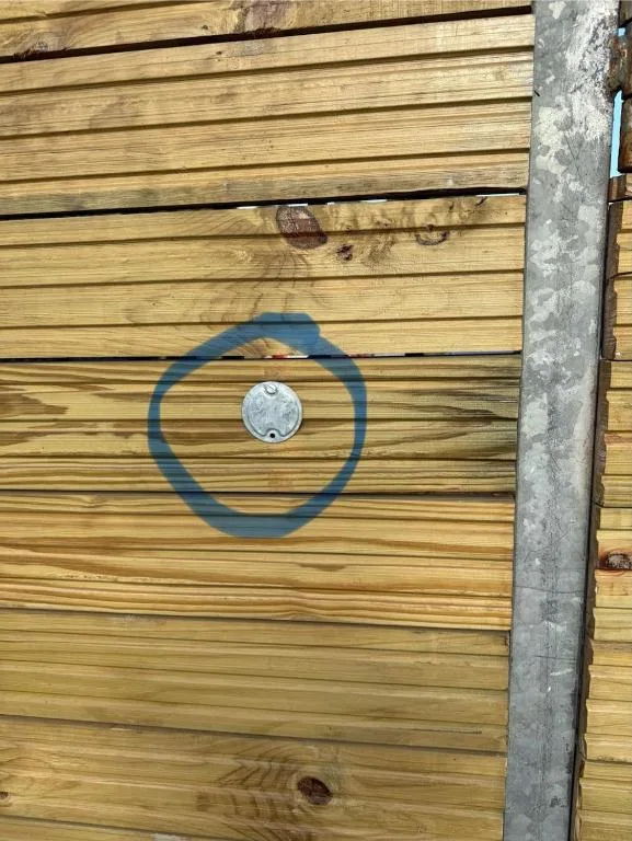 Metal circular design and outlet on wooden deck panel