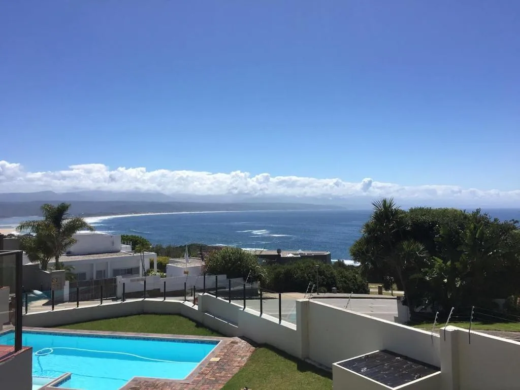 Panoramic ocean and coastal landscape view from elevated property overlooking bay