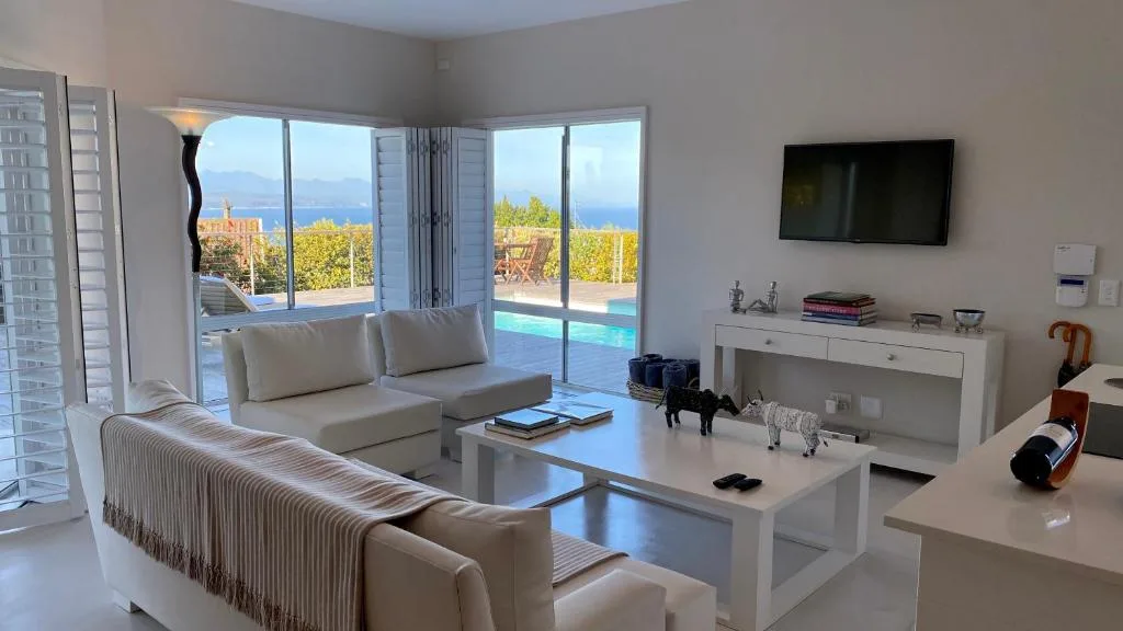 Modern lounge with ocean views through large windows and contemporary furnishings