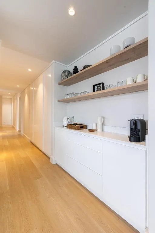 Modern kitchen shelving with coffee maker and white cabinetry storage