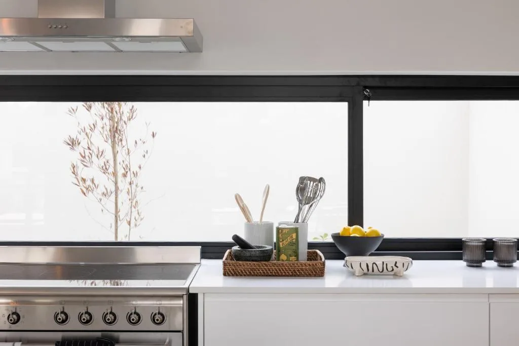 Modern kitchen with stainless steel appliances and white countertops