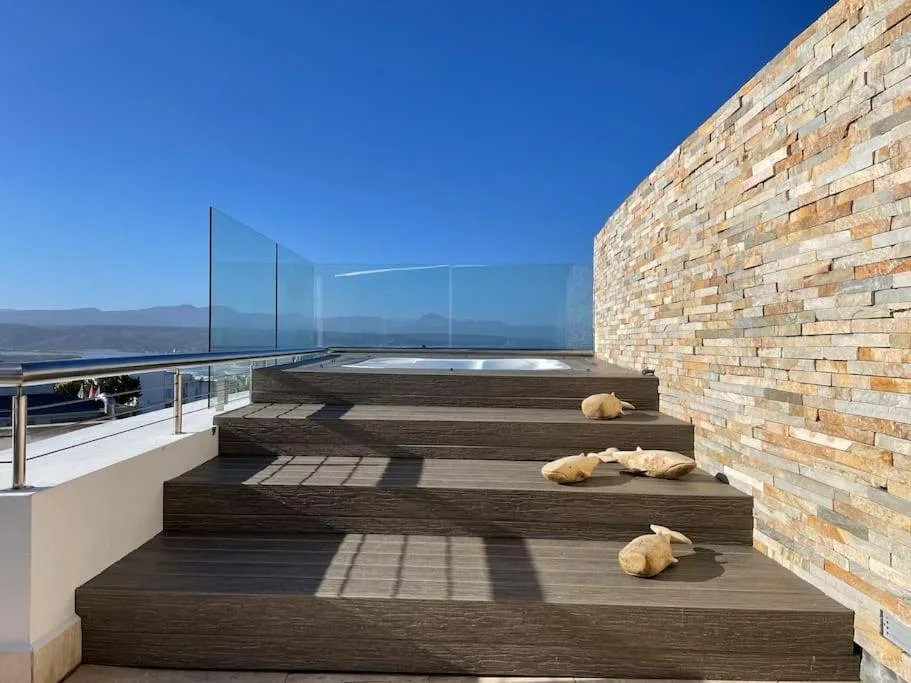 Modern wooden deck with glass railings overlooking mountain views